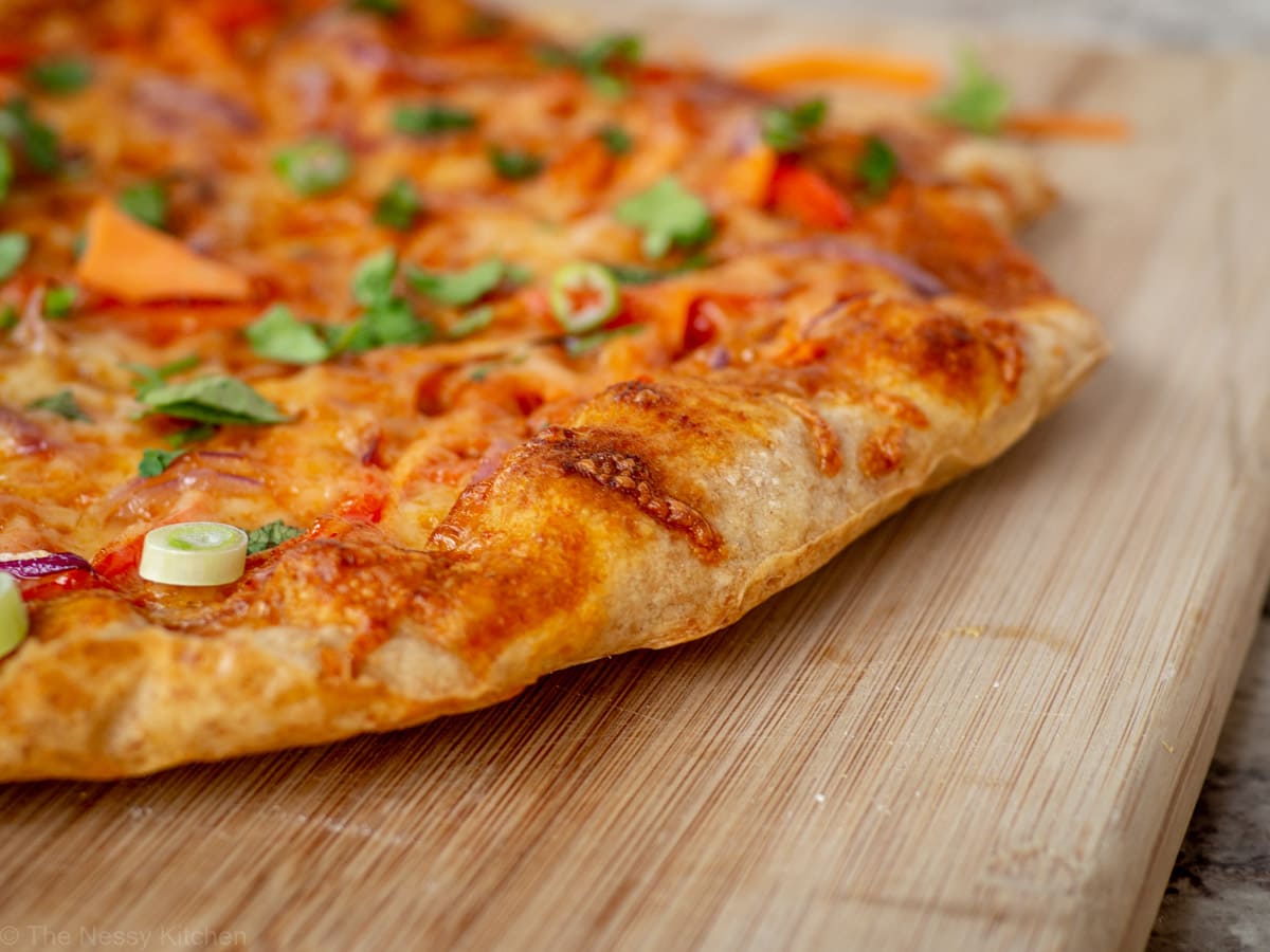 Close up shot of the chewy homemade artisan crust of the Thai curry pizza.