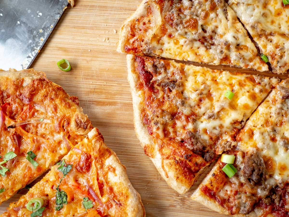 Sliced pizza on a cutting board.