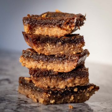 Butter tart bars sliced and stacked on top of one another.