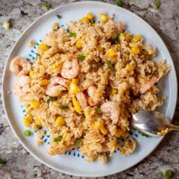 Plate of rice, corn, shrimp and rice.