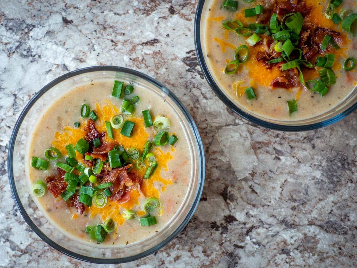 Potato soup in 2 glass storage containers.