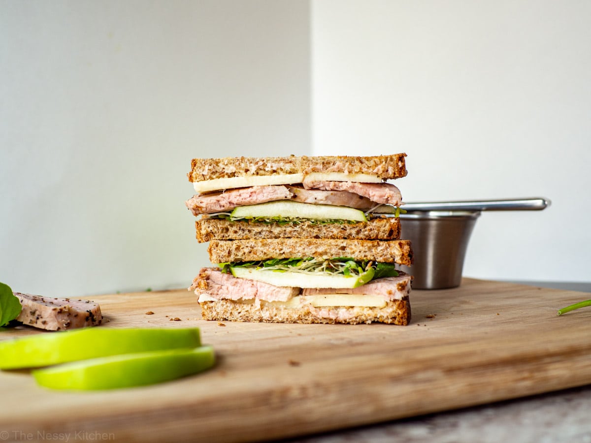 Pork tenderloin sandwich on a cutting board.