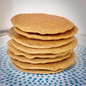 Stack of oatmeal pancakes on a plate.