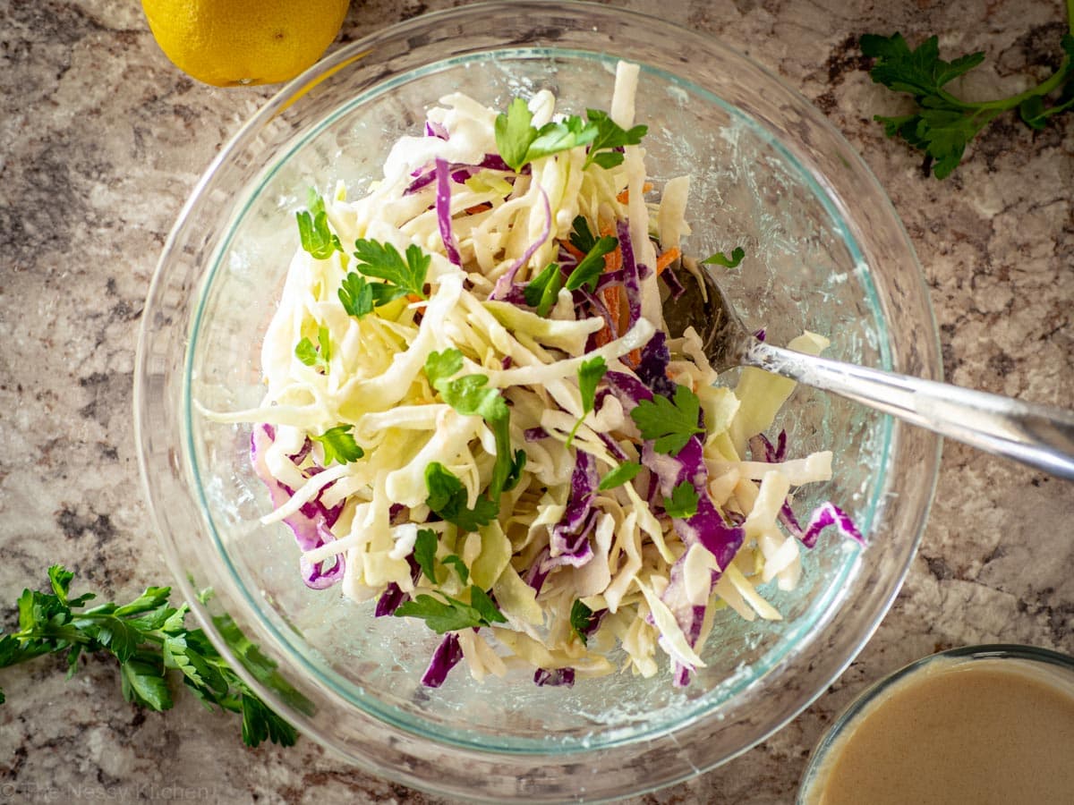 Bowl of slaw with a serving fork.