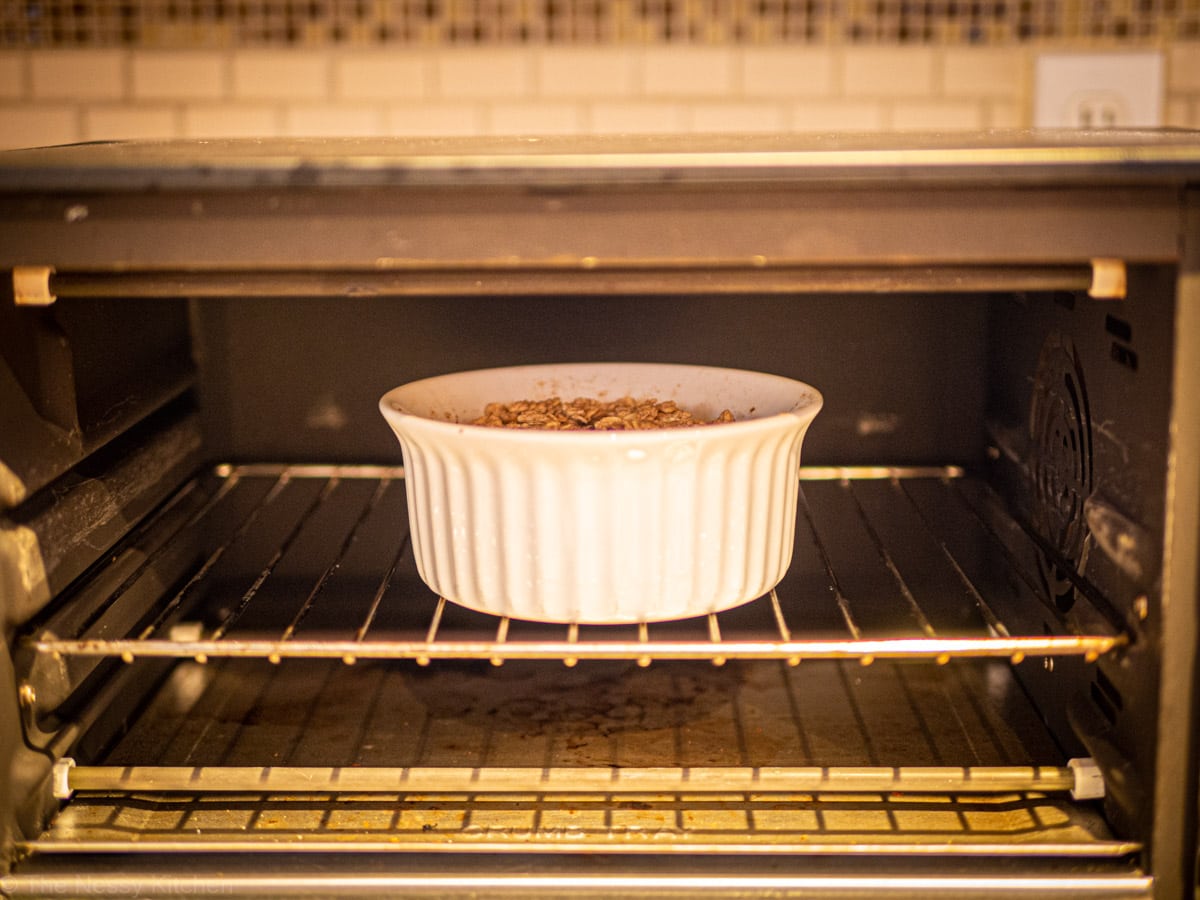 Small dish of apple crisp in a toaster oven.