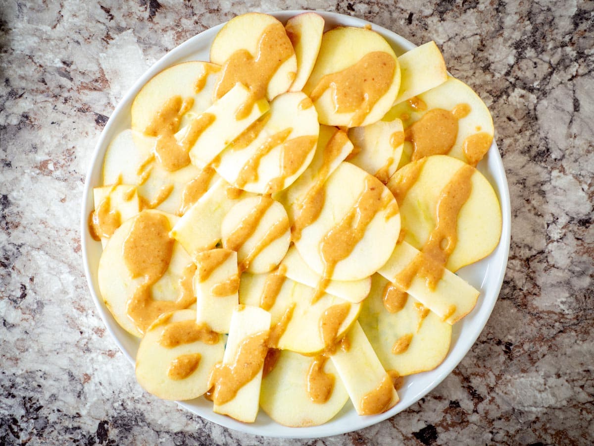 Sliced apples drizzled with macadamia nut butter.