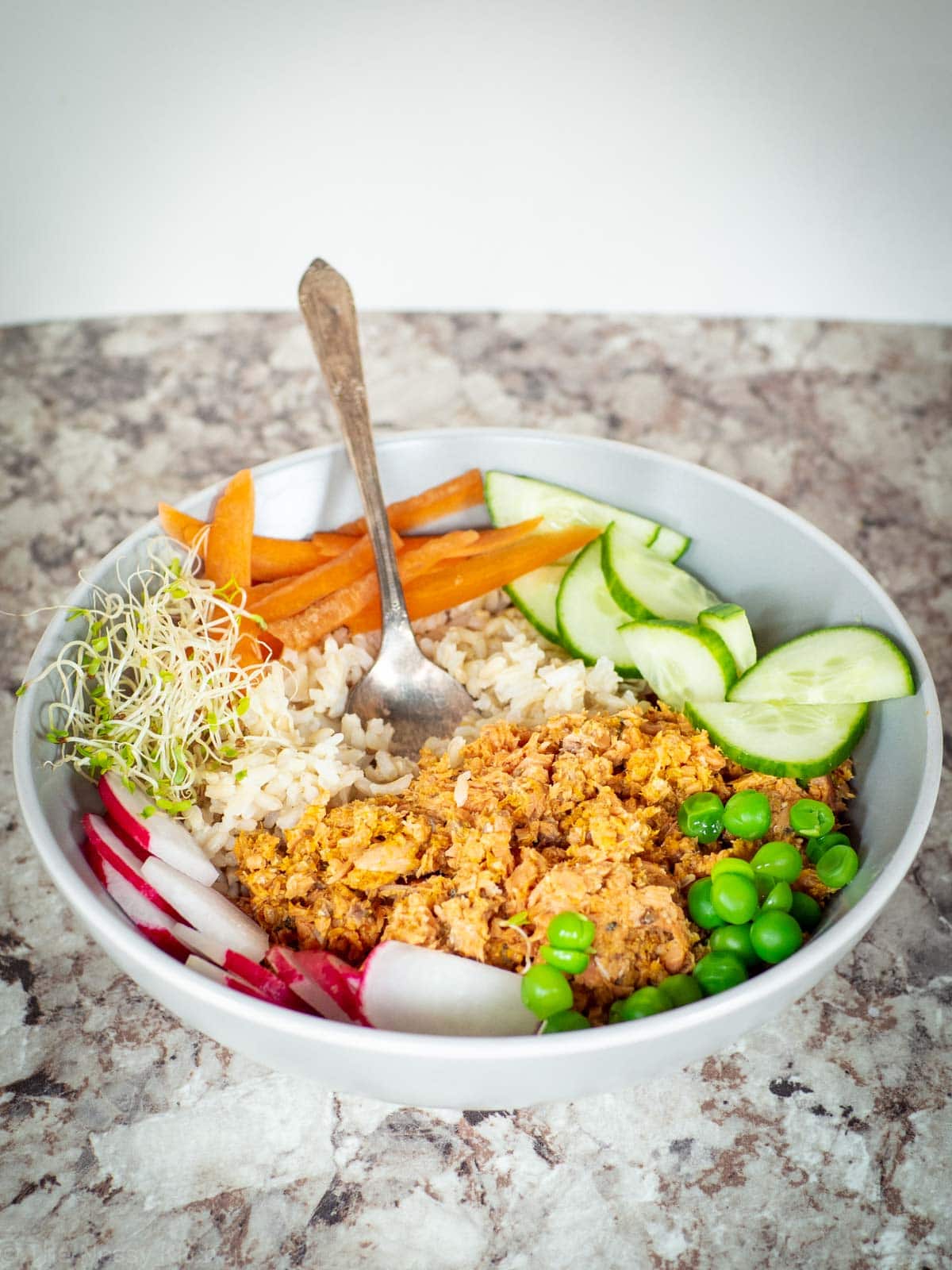 Bowl of rice, canned salmon and vegetables.