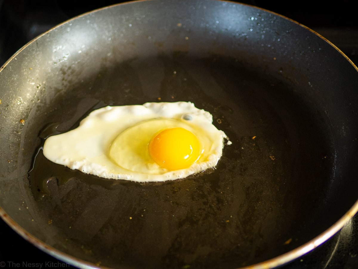 Egg being fried in a hot pan.