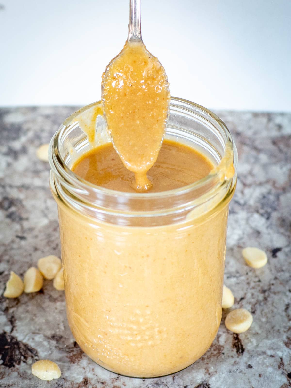 Spoonful of nut butter scooped from a jar.