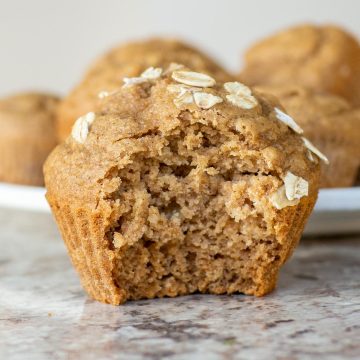 Oat flour apple muffin with a bite taken out.