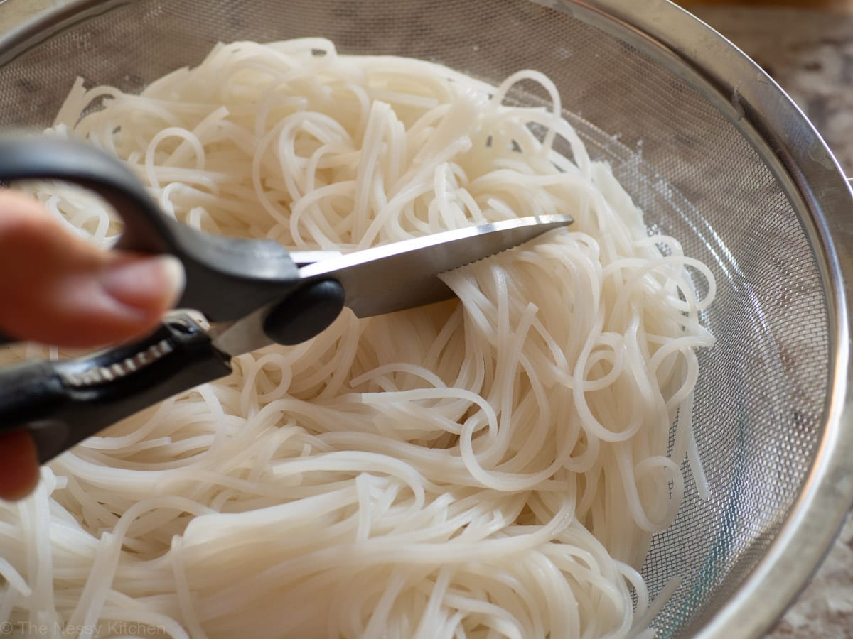 Scissors cutting vermicelli noodles.