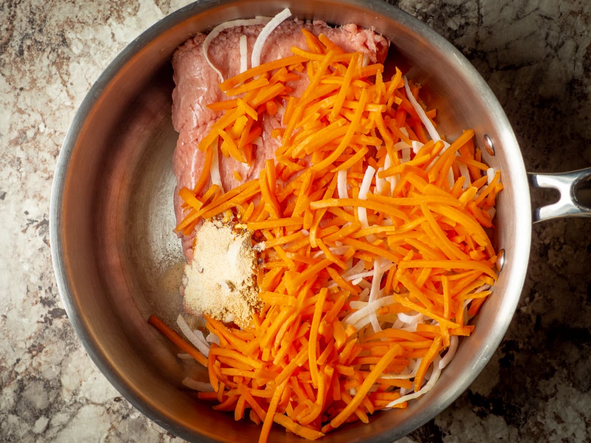 Ground turkey, carrots and onions in a large saucepan.