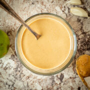 Bowl of peanut sauce with a spoon in it.