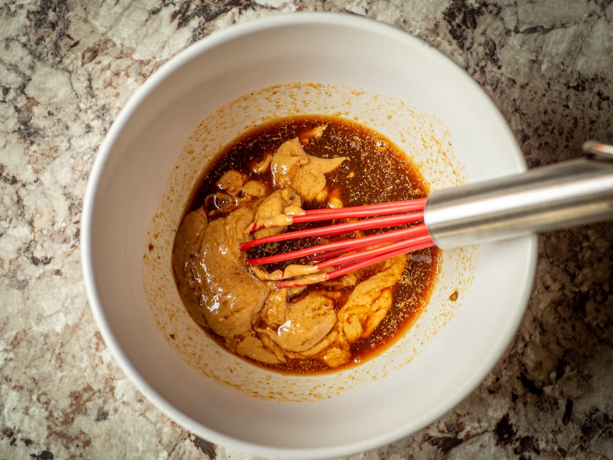 Peanut sauce whisked in a small mixing bowl.