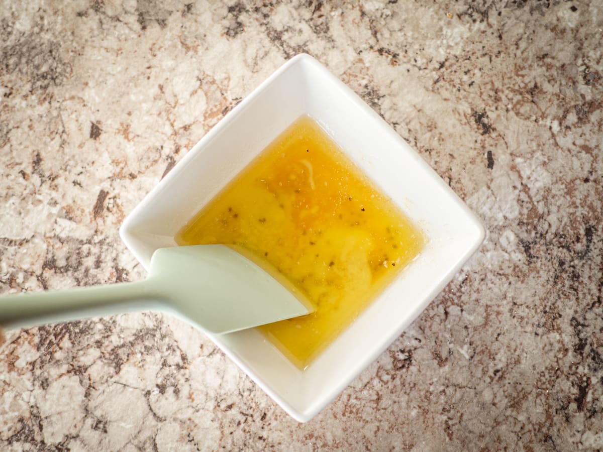 Butter and seasonings mixed together in a small bowl.
