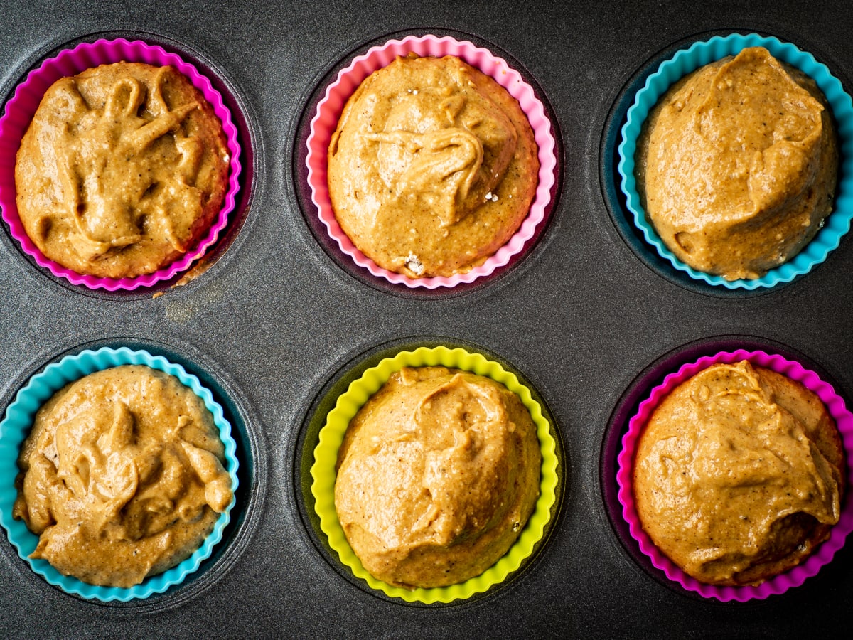 Muffin batter divided into tins.