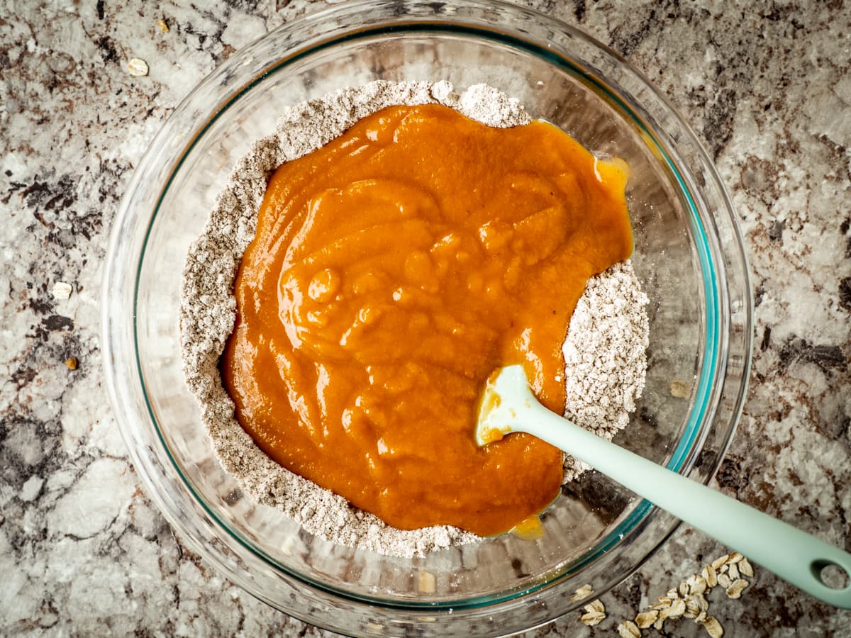 Wet and dry ingredients being combined with a spatula.