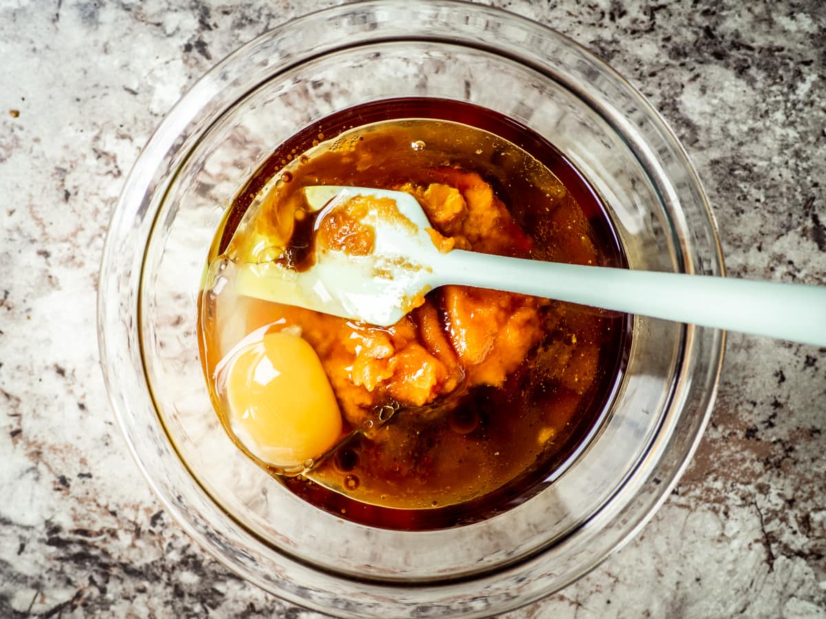 Wet ingredients mixed together in a glass bowl.