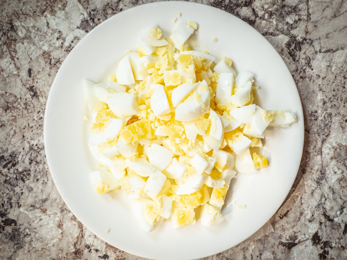 Diced, hard boiled eggs on a plate.