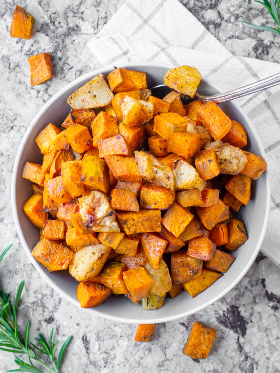 Bowl of sweet potatoes with a spoon.