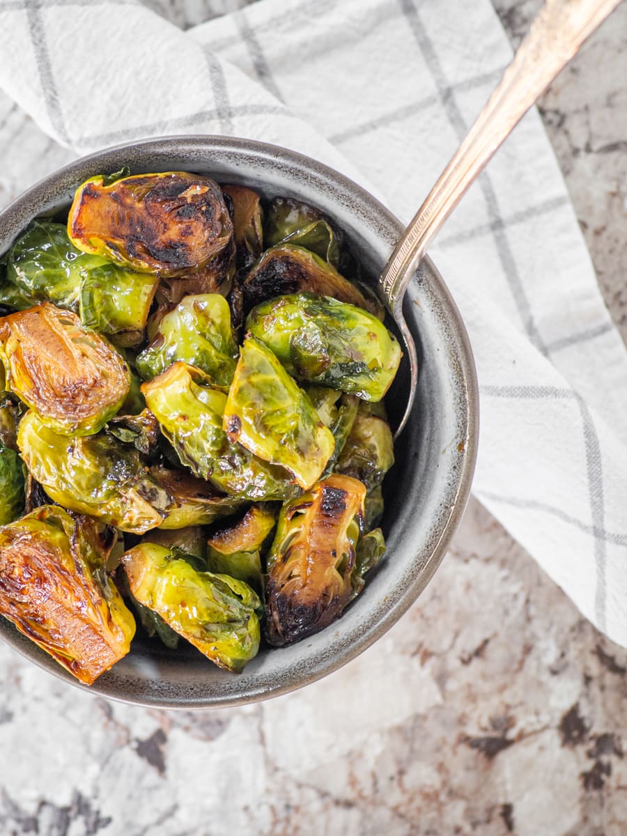 Bowl of Brussels sprouts with a serving spoon.