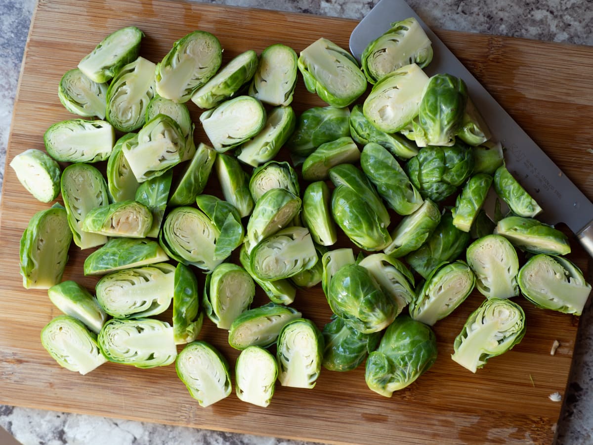 Sliced Brussels sprouts on a cutting board.