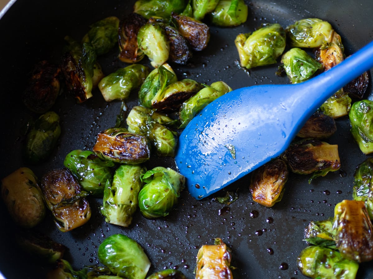 Brussels sprouts stirred to coat with vinegar.