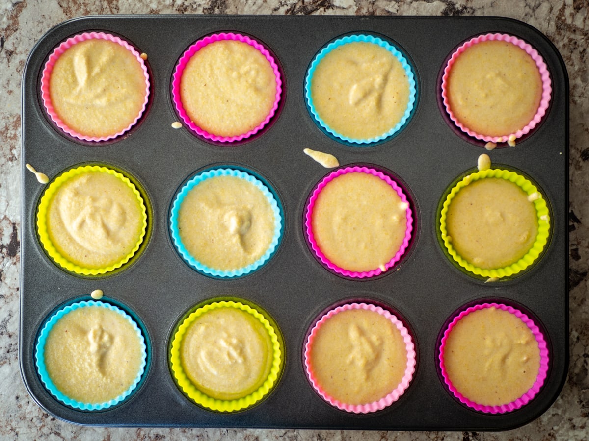 Muffin batter divided among muffin tins.