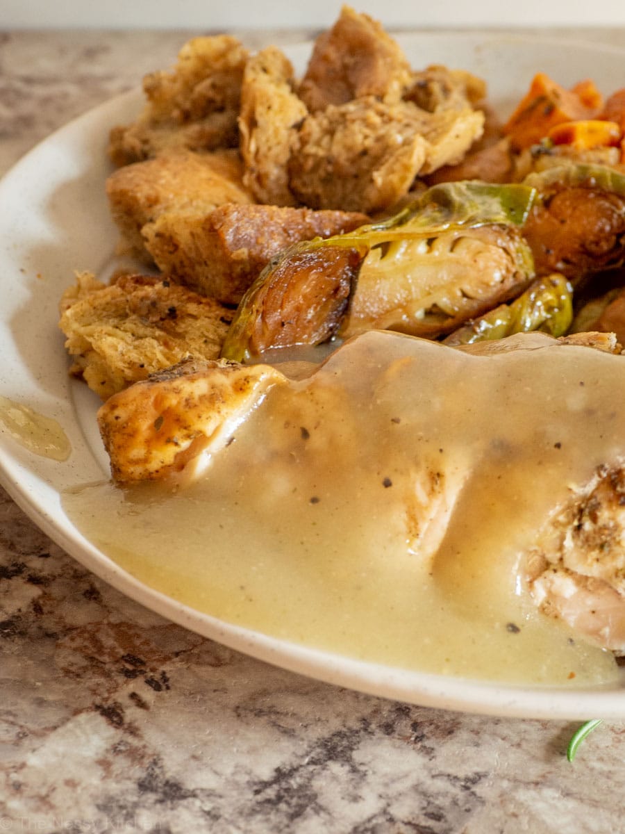 Plate of roast chicken and stuffing with gravy.