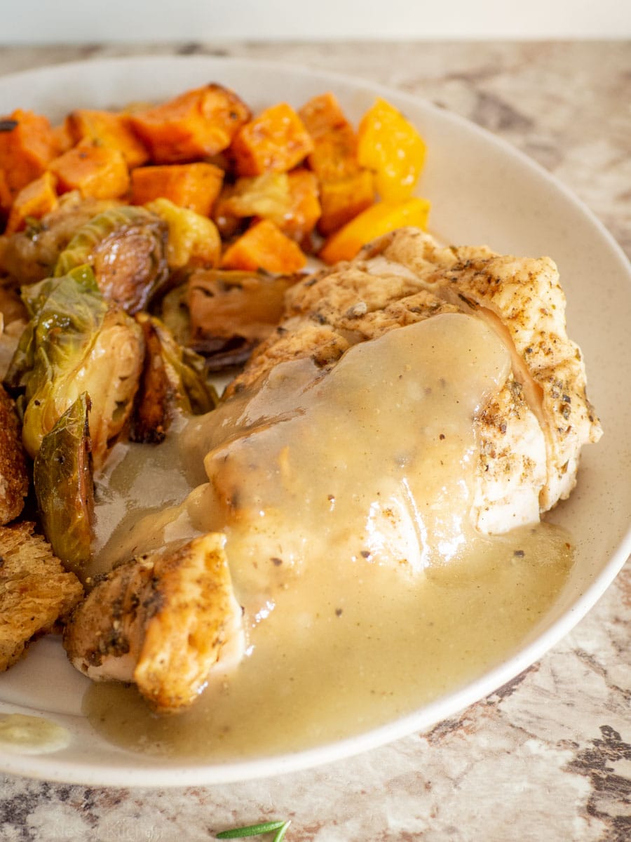 Roasted chicken topped with gravy.