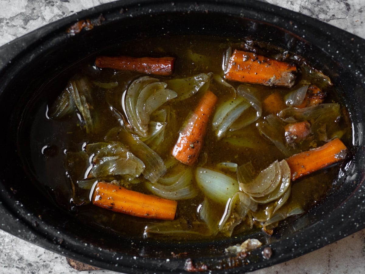 Chicken drippings in a roasting pan.