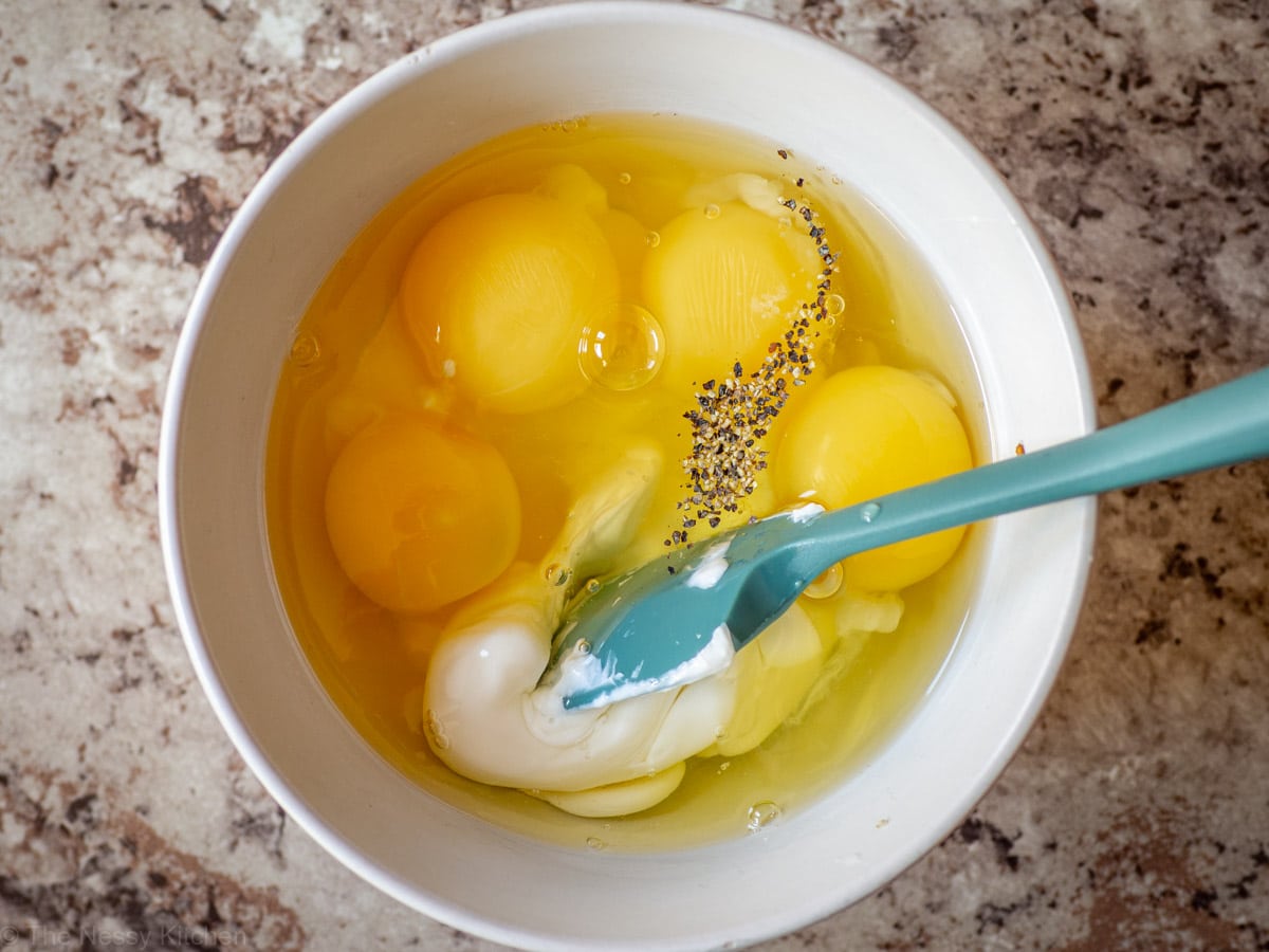 Eggs and Greek yogurt mixed together in a small bowl.