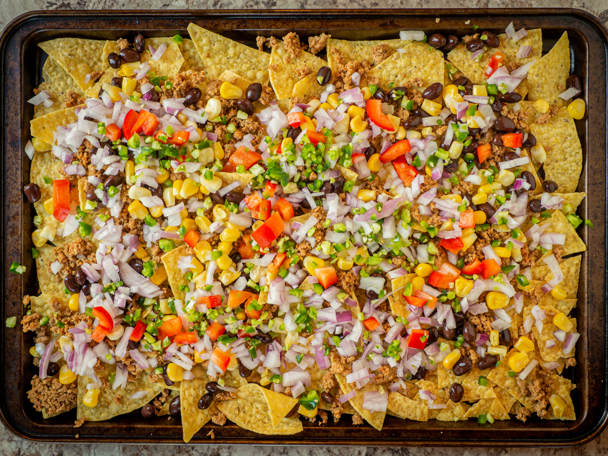 Vegetables spread out over tortilla chips.