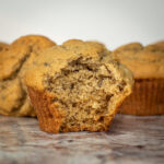 Banana muffin with a bite taken out.