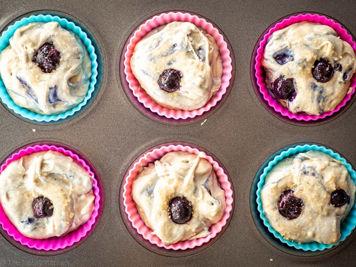 Muffin batter divided into muffin tins.