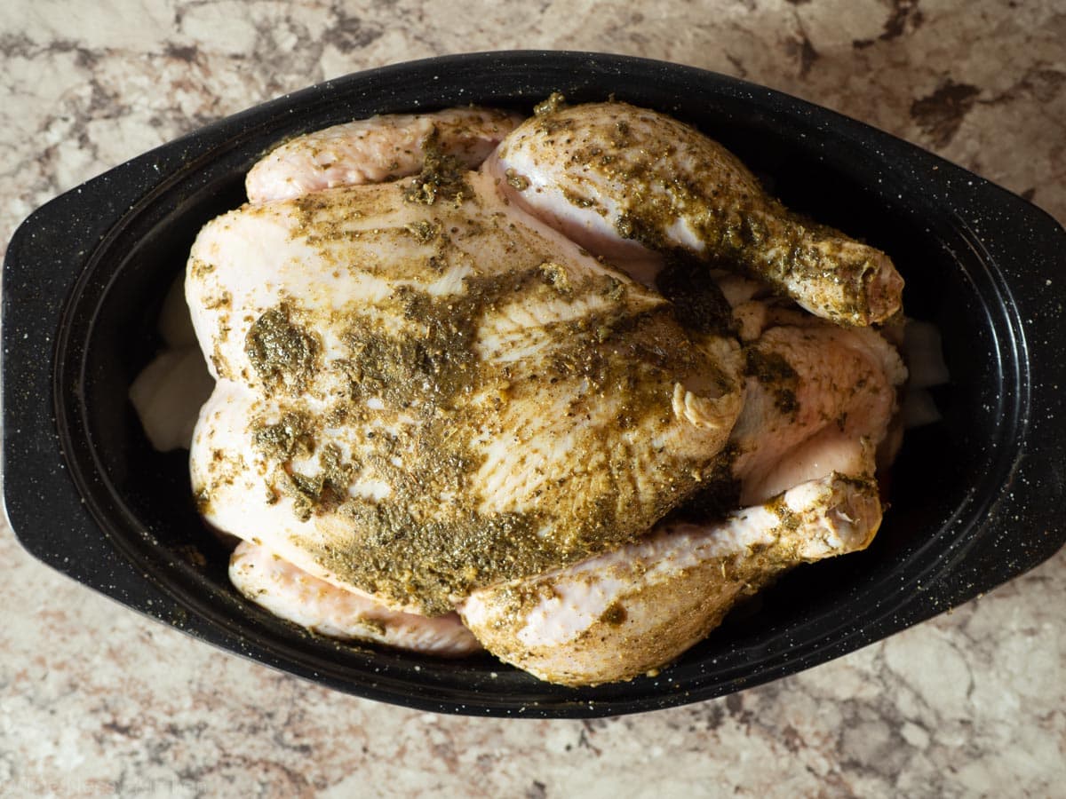 Raw chicken brushed with herb butter.