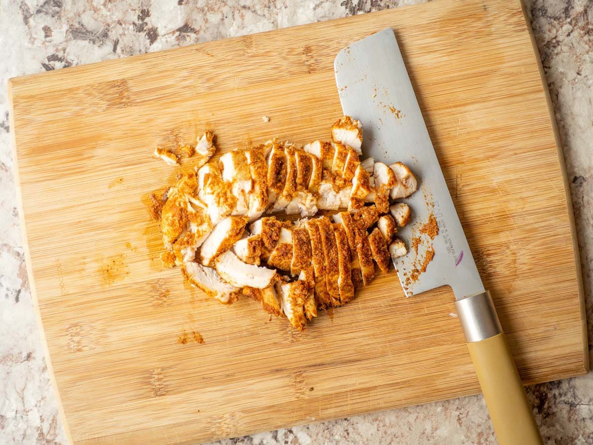 Chicken sliced on a cutting board.
