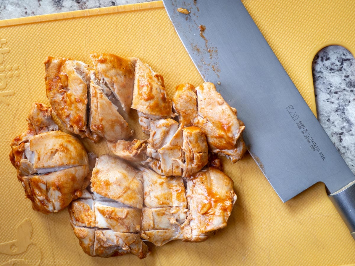 Chicken diced on a cutting board.