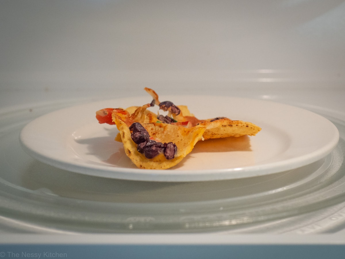 Nachos on a plate in the microwave.