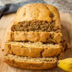Banana bread sliced on a cutting board.