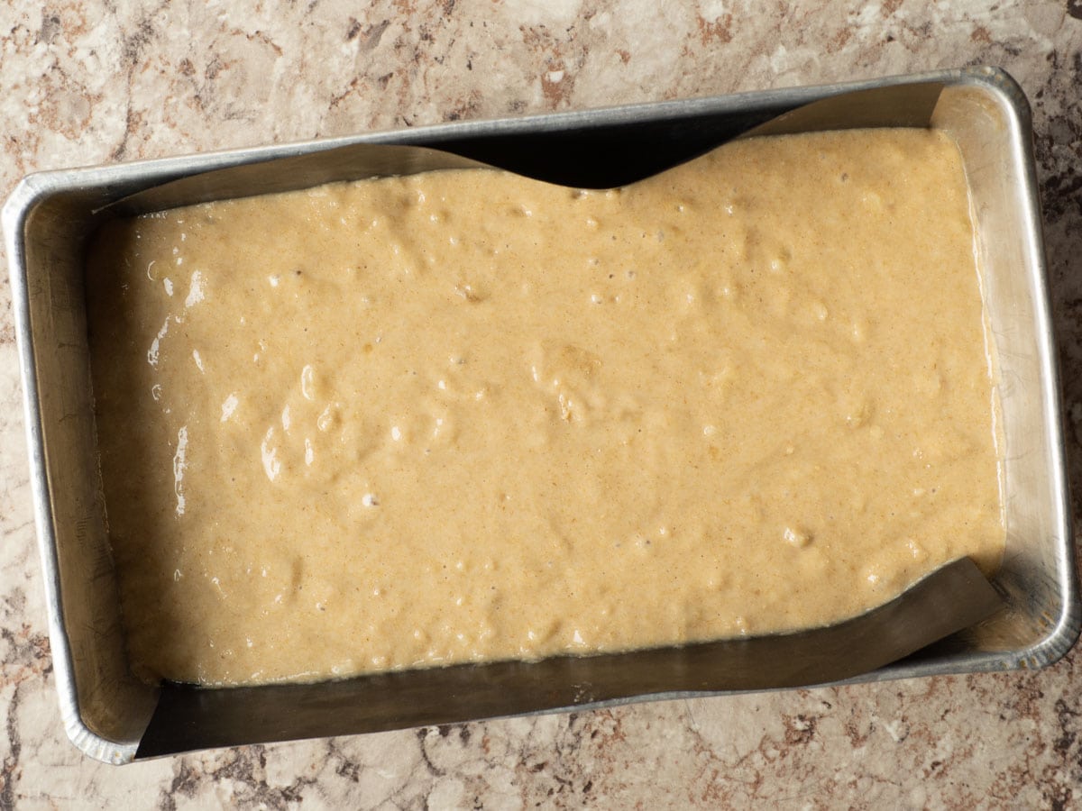 Loaf pan filled with oat flour banana bread batter.