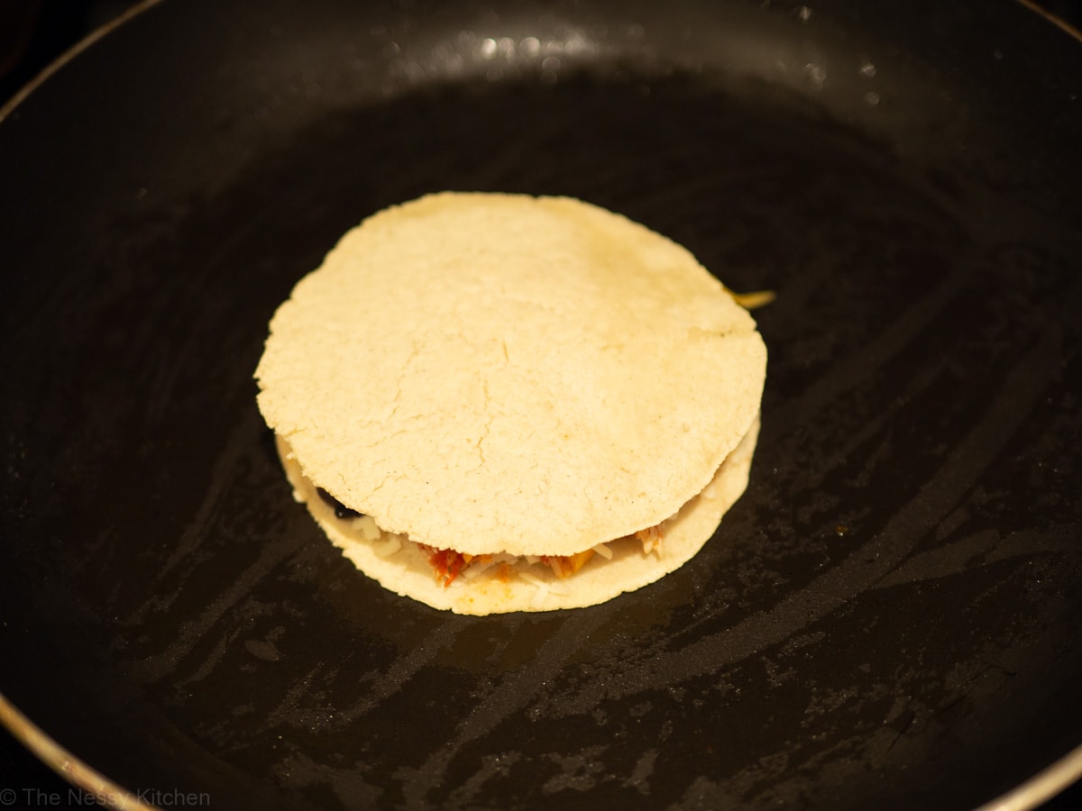 Quesadilla cooking in a skillet.