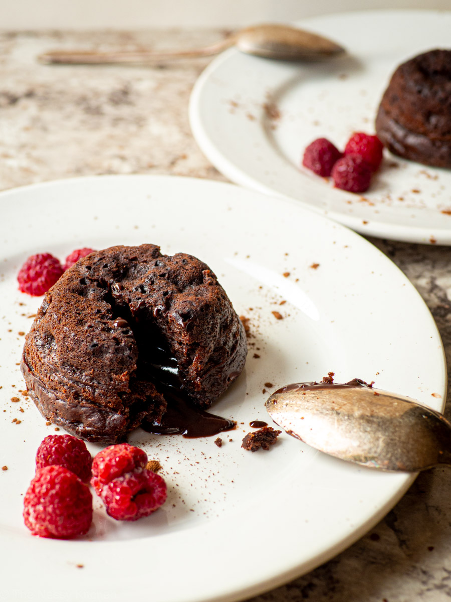 Lava cakes on a plate with berries.