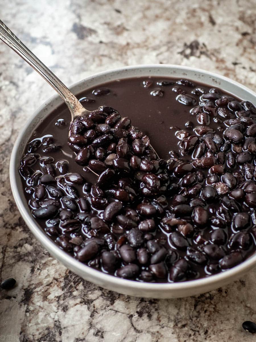 Spoon scooping a bite of black beans.