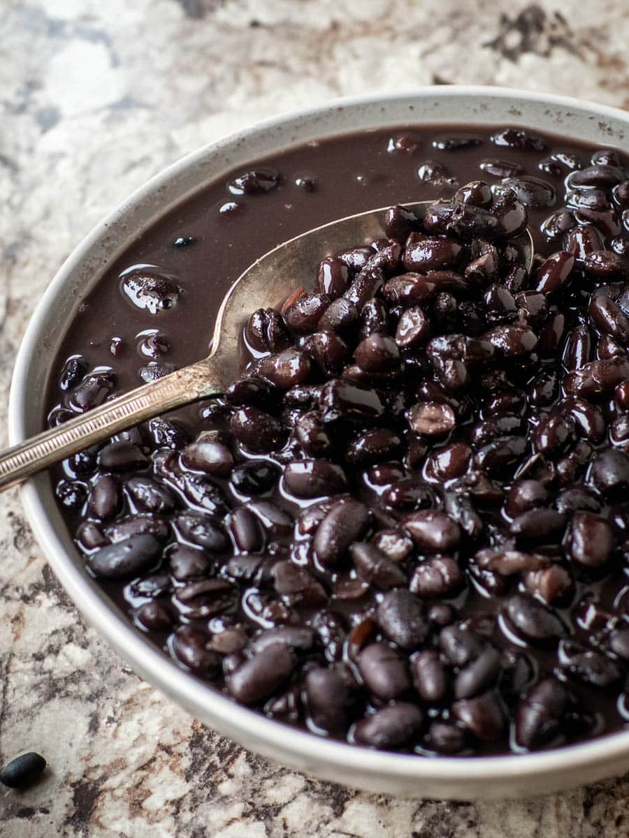 Bowl of cooked black beans.