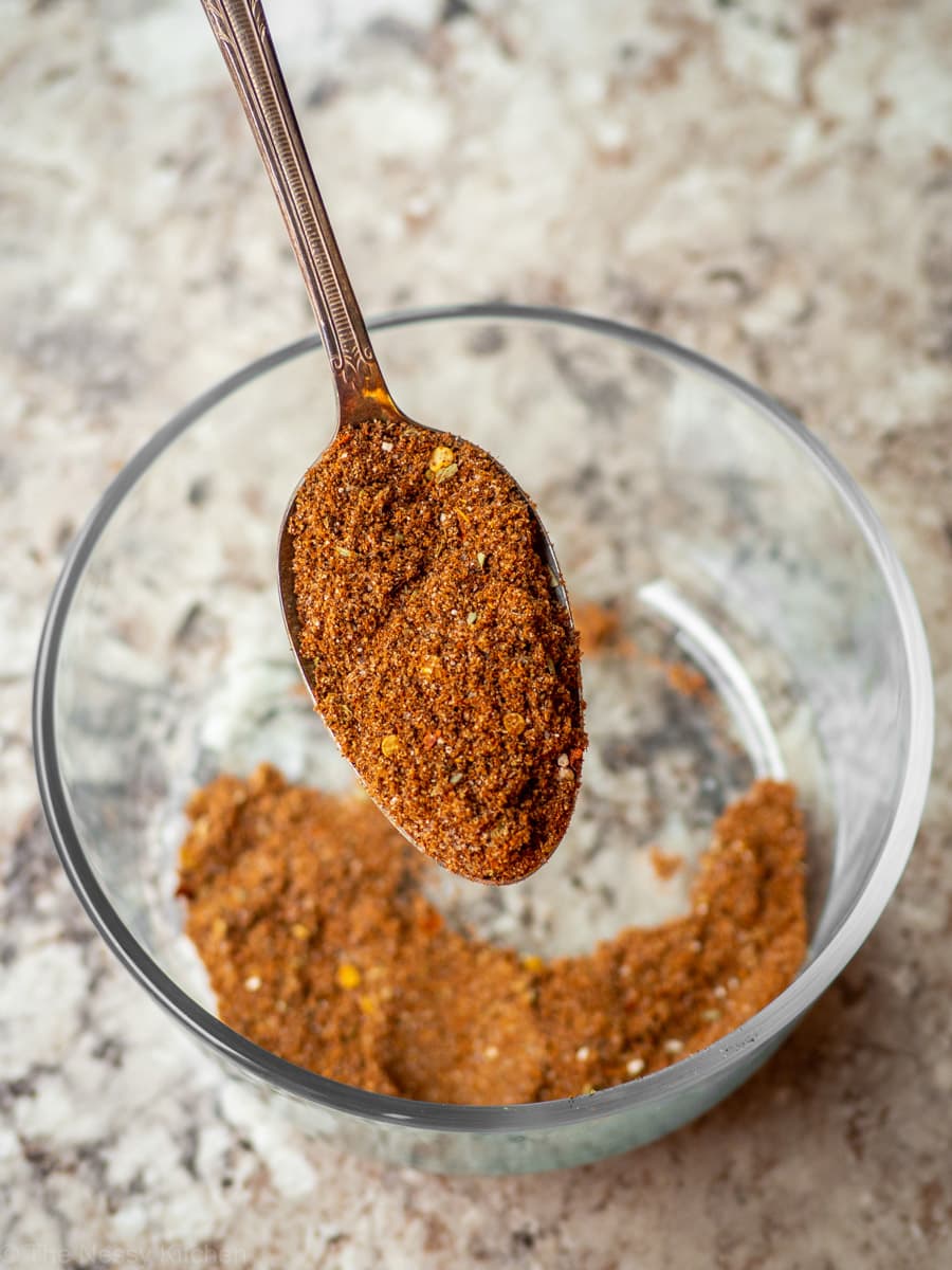 Spoon scooping a portion of taco seasoning.