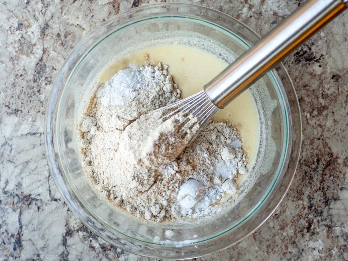 Flour added to the bowl of ingredients.