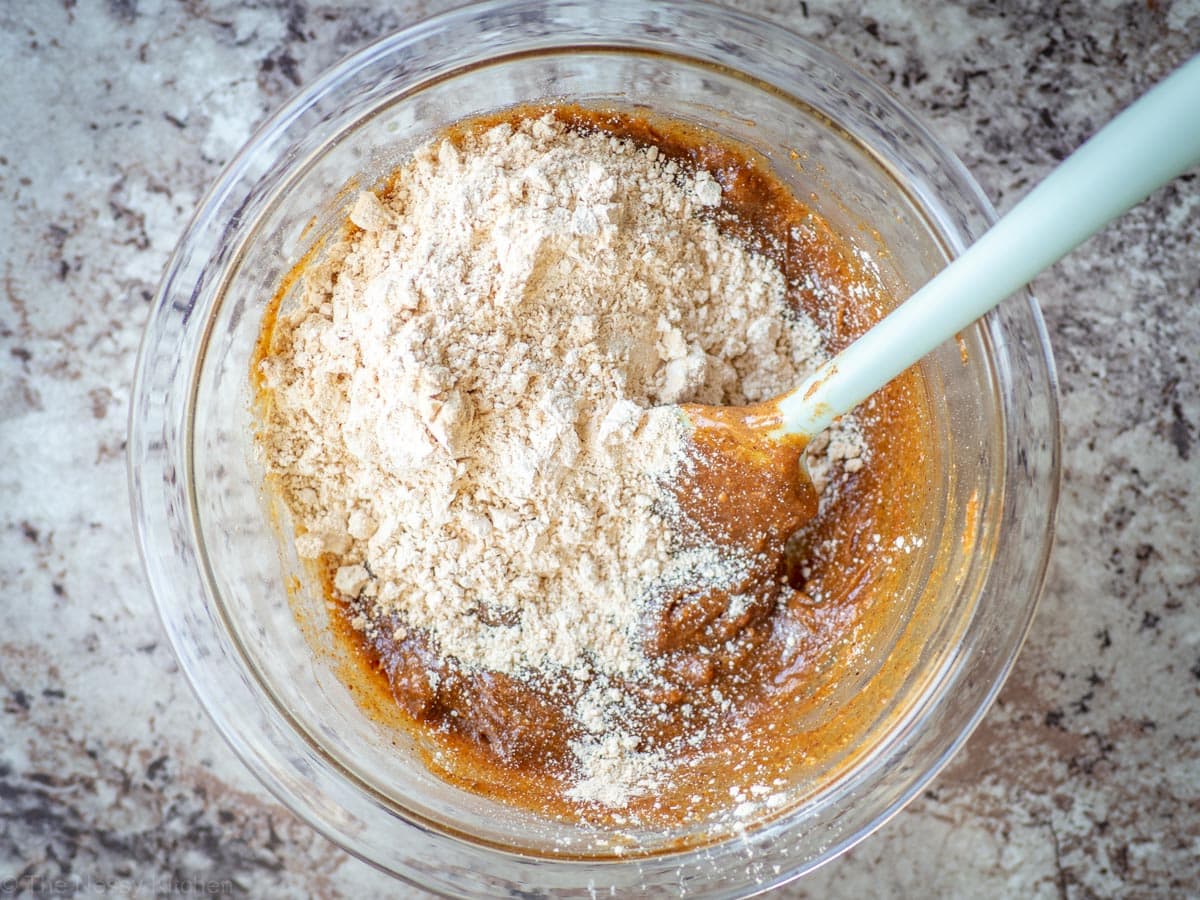 Protein powder added to a mixing bowl.