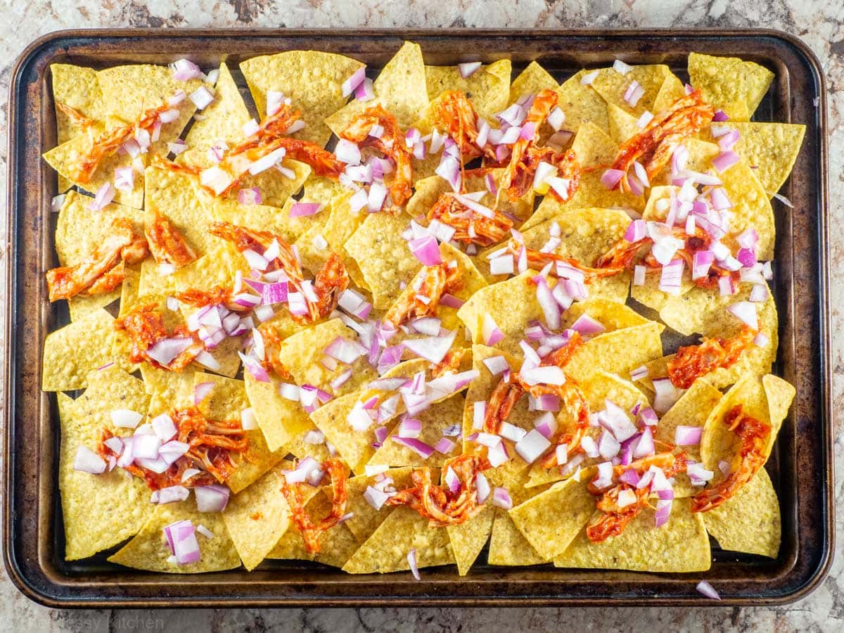 Chicken and onion spread on tortilla chips.