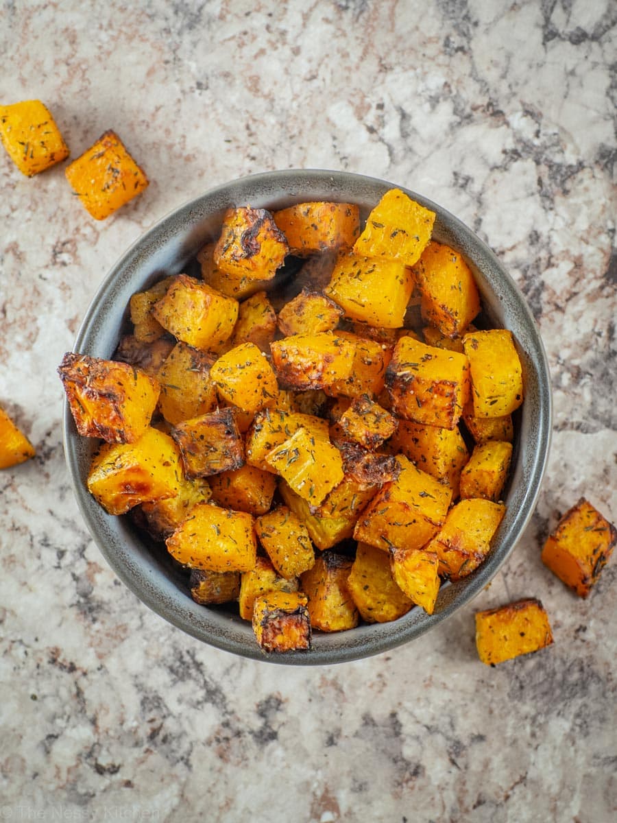 Cooked squash cubes in a serving bowl.